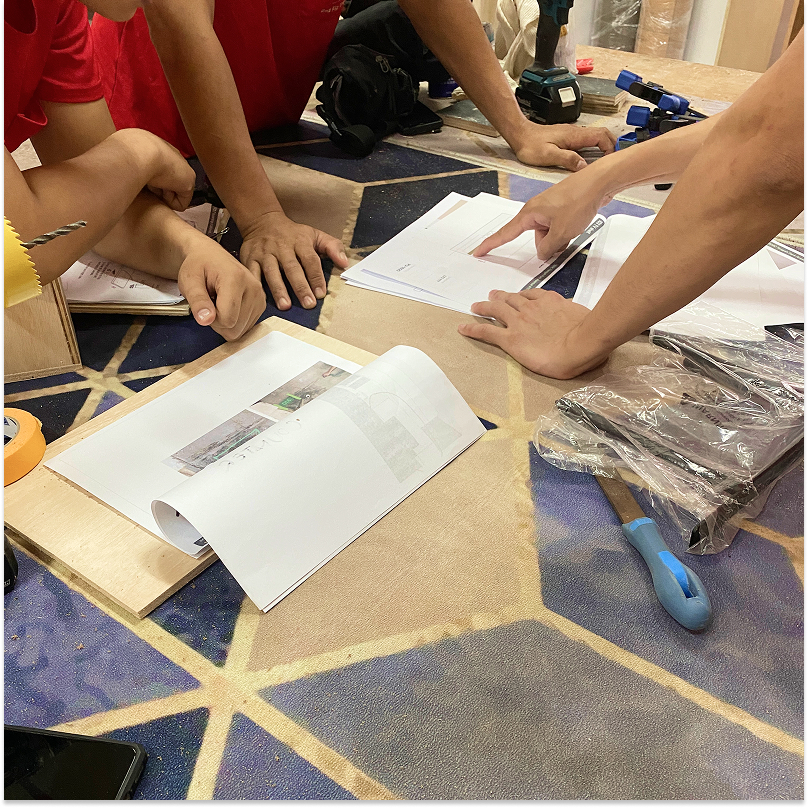 Explaining drawings to workers